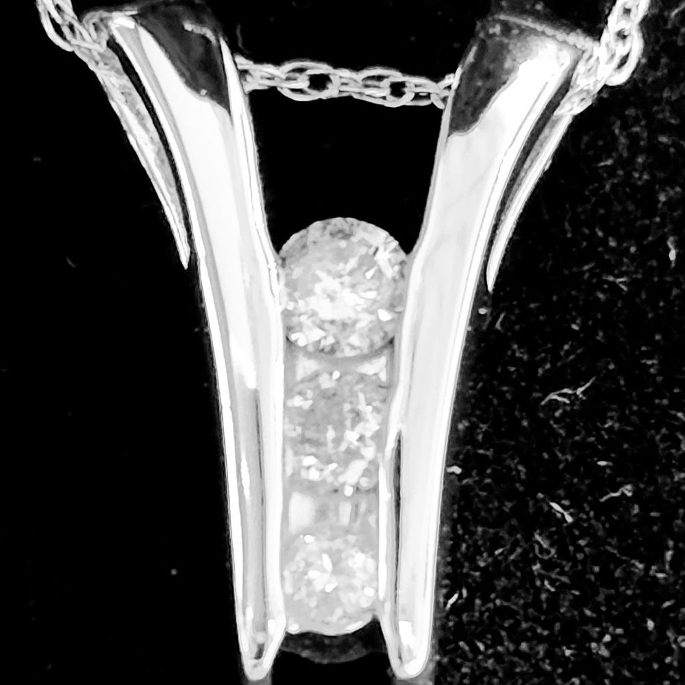 Macy's 14 karat white gold diamond pendant. 1/6 carat